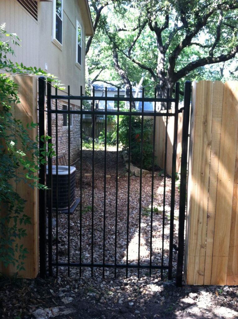 Ornamental gate at wood fence built by Sierra Fence