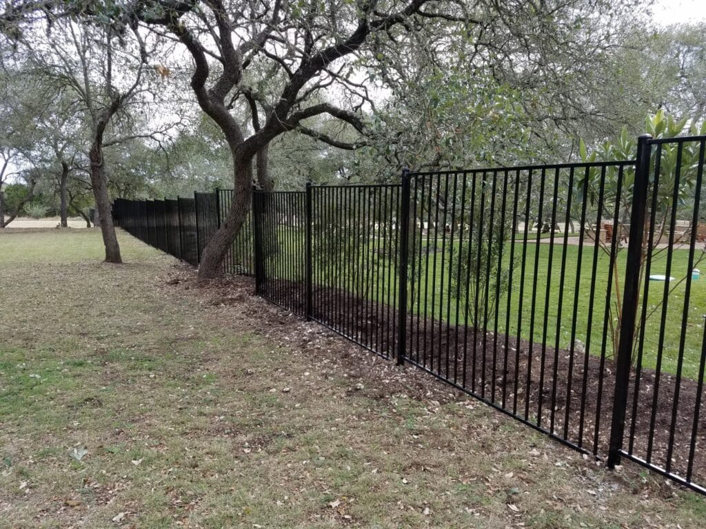 Stair stepped installation of 6ft tall ornamental steel fence
