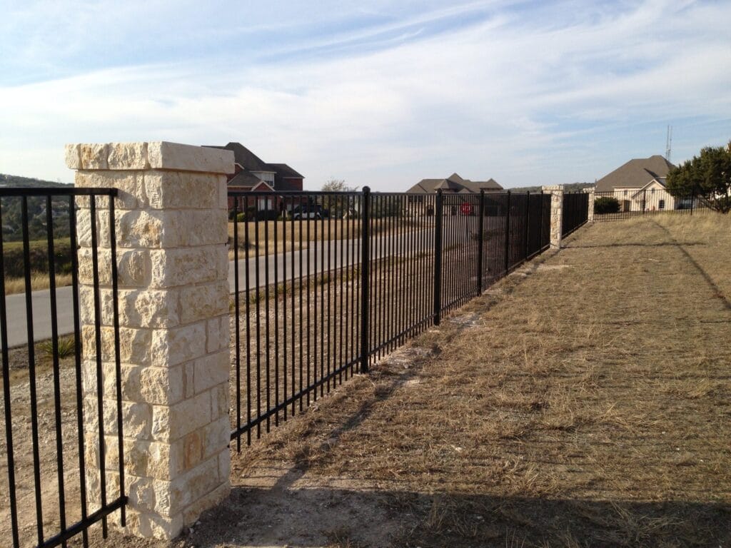 Ornamental steel fence with stone columns