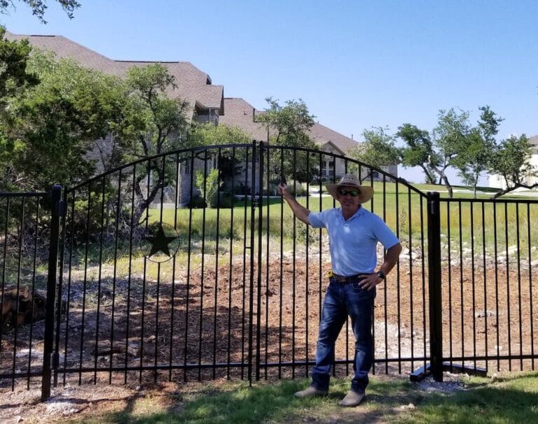 richard with iron ornamental fence and gate