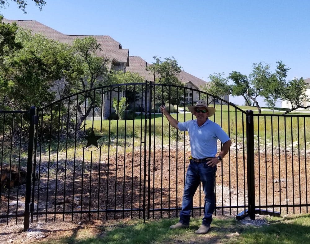 richard with iron ornamental fence and gate