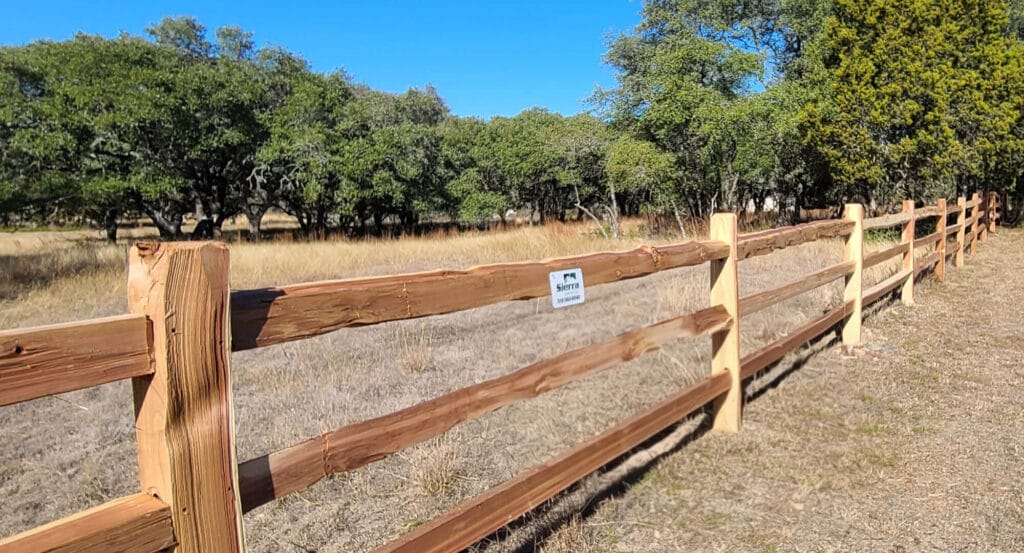 Jumbo-rail split-rail fence with oversized cedar rails.