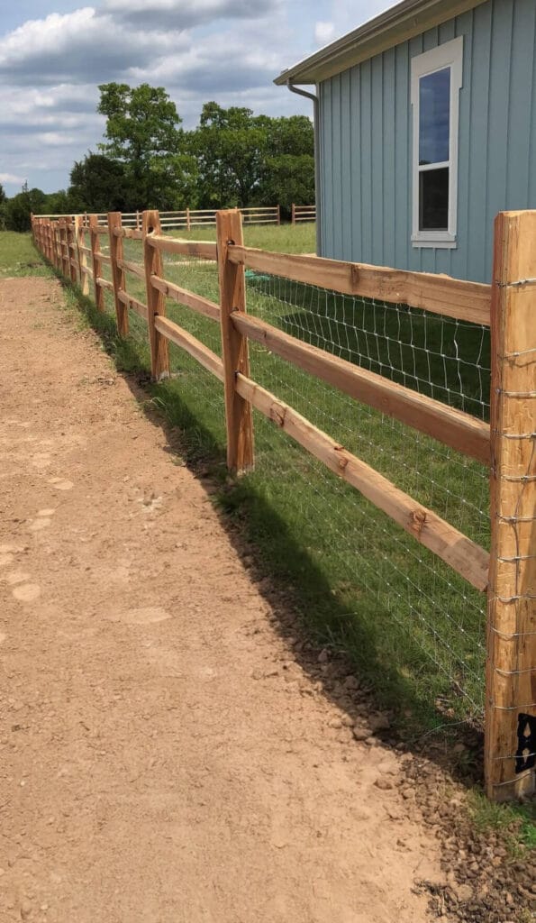 Split-rail fence with wire mesh added for extra containment.