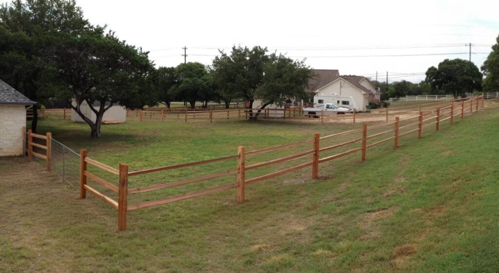 Yard defined by a split-rail fence.