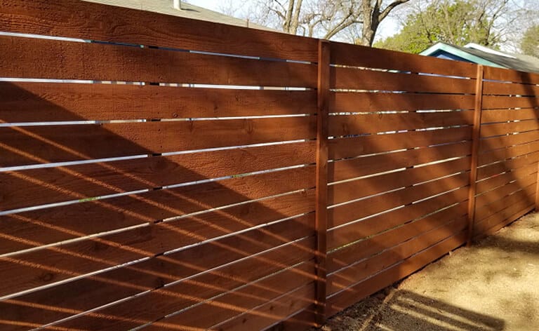 Family-owned fence company in Bee Cave installing custom horizontal wood fences