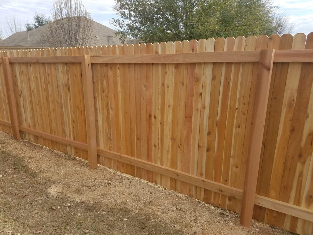 Two-rail cedar privacy fence built with durable traditional construction