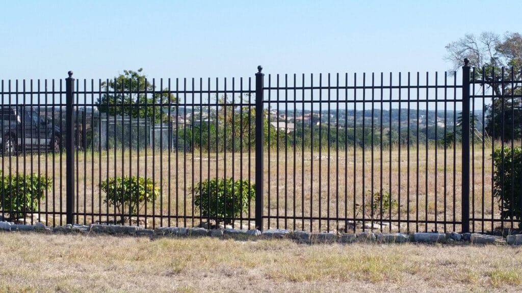 Ornamental iron fence with finial posts defining property boundaries in classic style.