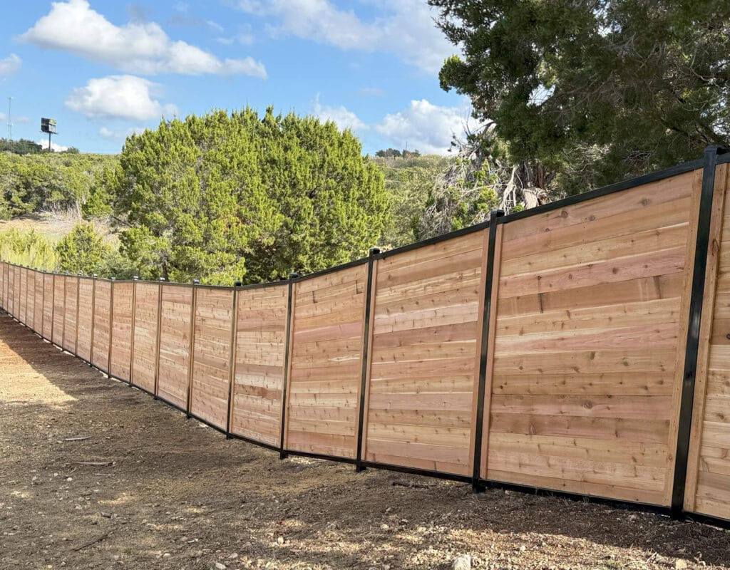 Seven-foot cedar horizontal fence following sloped terrain for smooth, modern privacy.