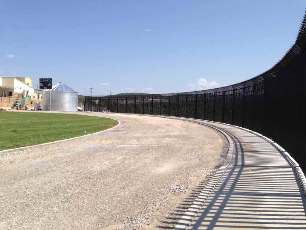 Curved-top 10-foot ornamental steel security fence providing premium protection and visual appeal.