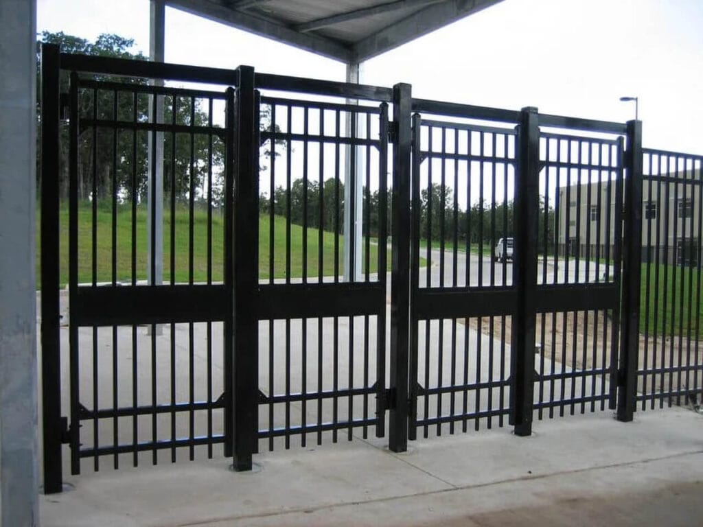 Commercial single swing steel security gate controlling vehicle entry at facility access point.