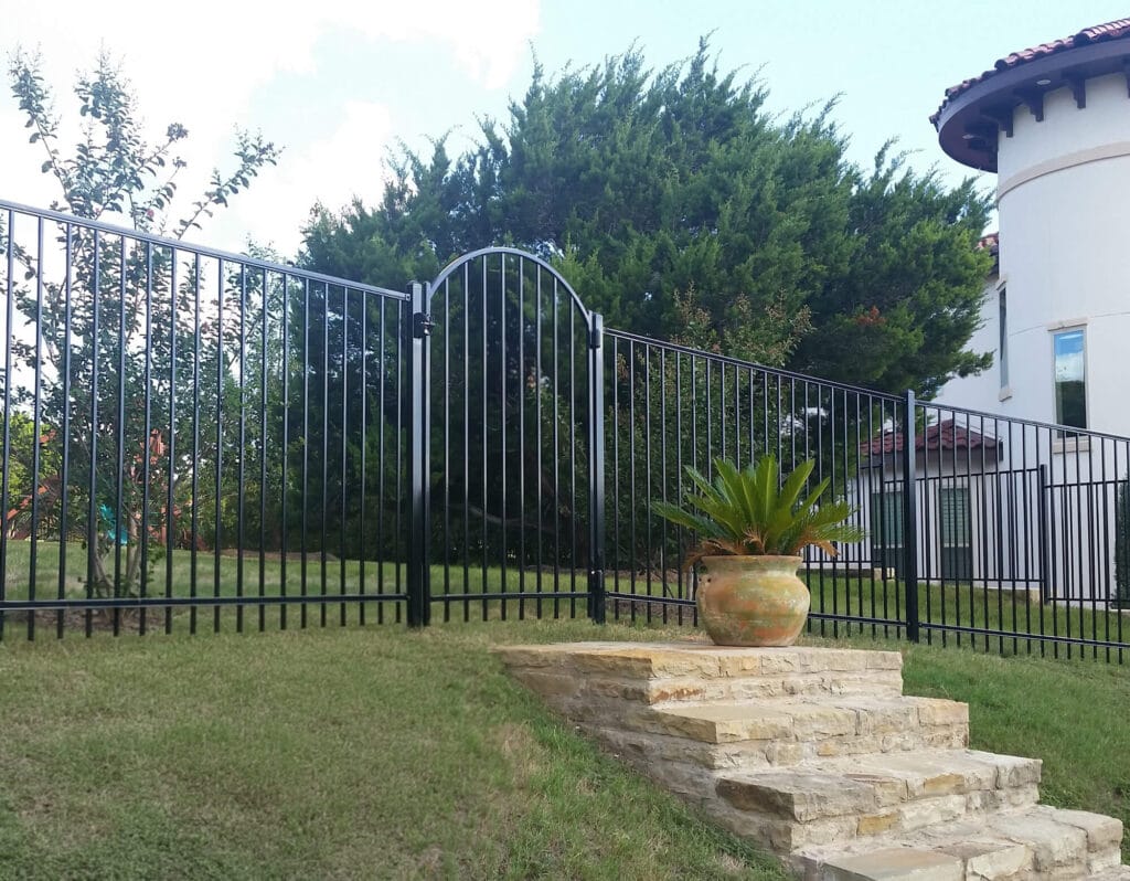 Ornamental steel fence with arched entry gate