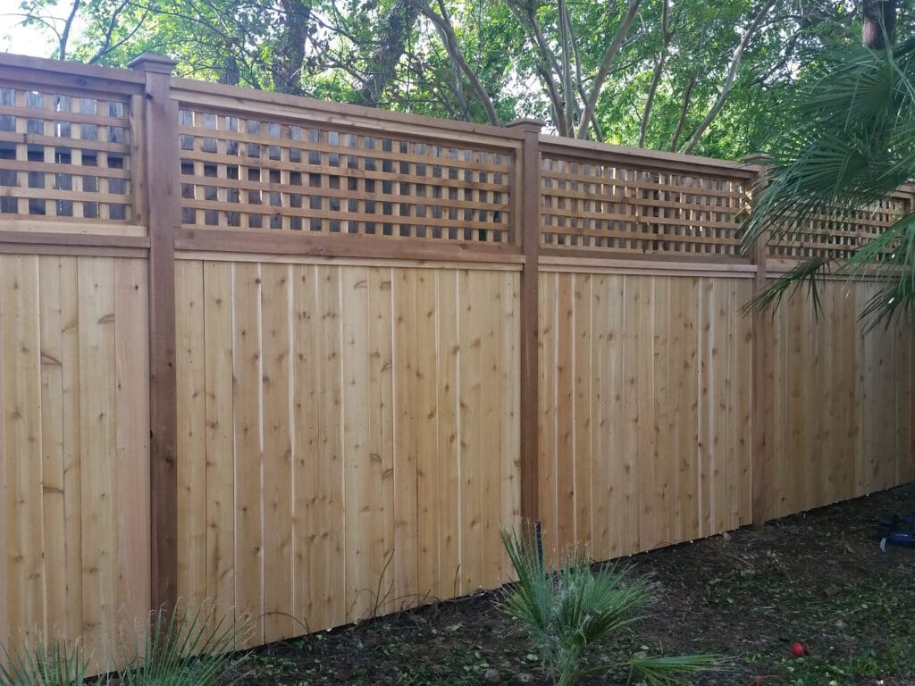 Custom lattice-top wood fence adding texture and character to backyard spaces