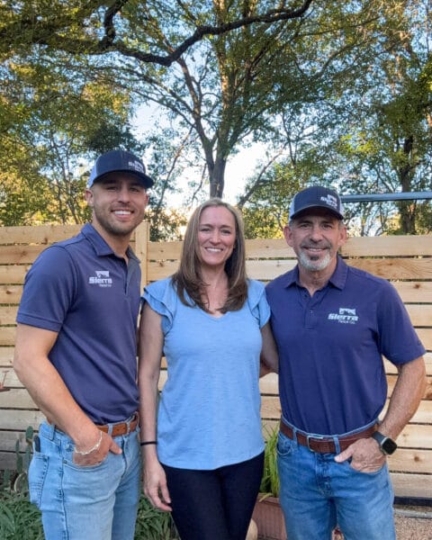 Sierra Fence crew, Cary Novigrod, Christian Mayo, and Hector Rendon, in front of a wood fence in Austin Texas