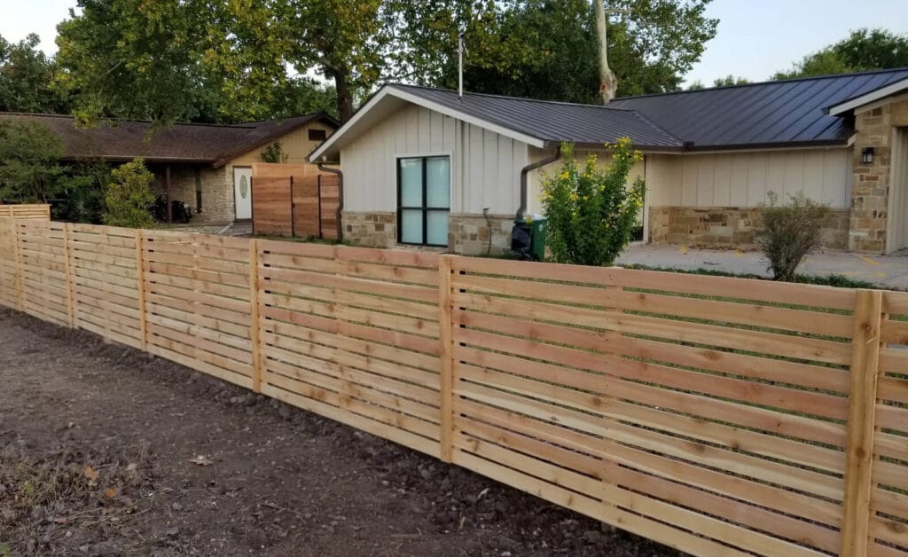 Horizontal cedar fence with narrow board gaps, 4-foot tall installation in Central Texas by Sierra Fence.