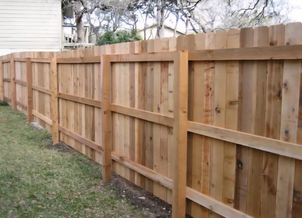 Three-rail cedar wood fence with natural cedar posts and classic Austin style