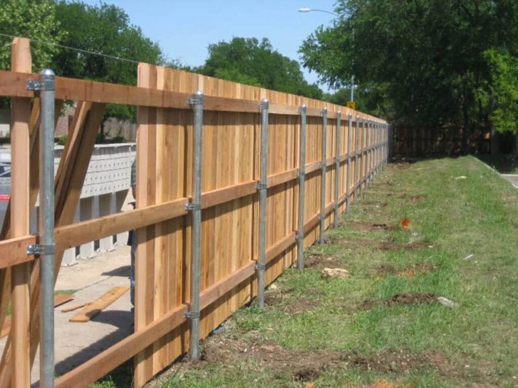 Three-rail cedar fence with steel posts for classic look and industrial-grade strength