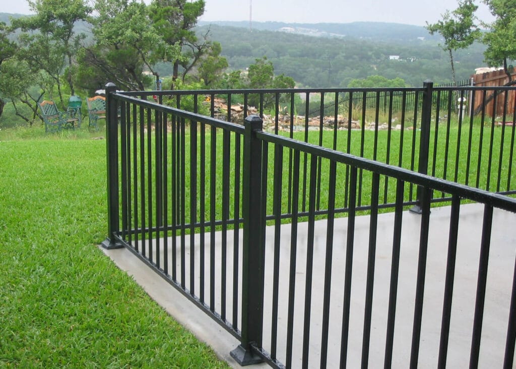 Decorative iron railing with plate-covered mounts for clean appearance
