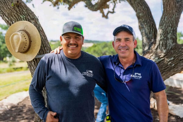 Sierra Fence workers posing near completed fence installation in Texas