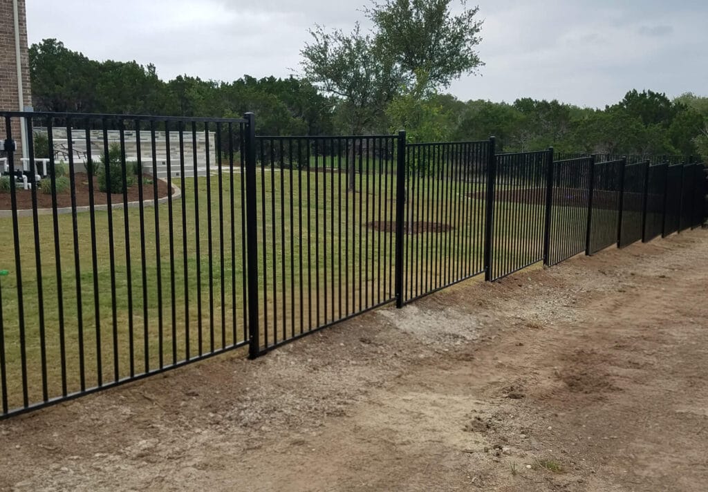 Stepped ornamental steel fence built to match sloped terrain