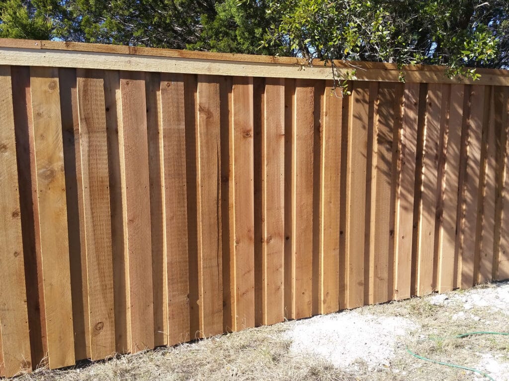 Board-on-board cedar privacy fence with cap and trim for full coverage