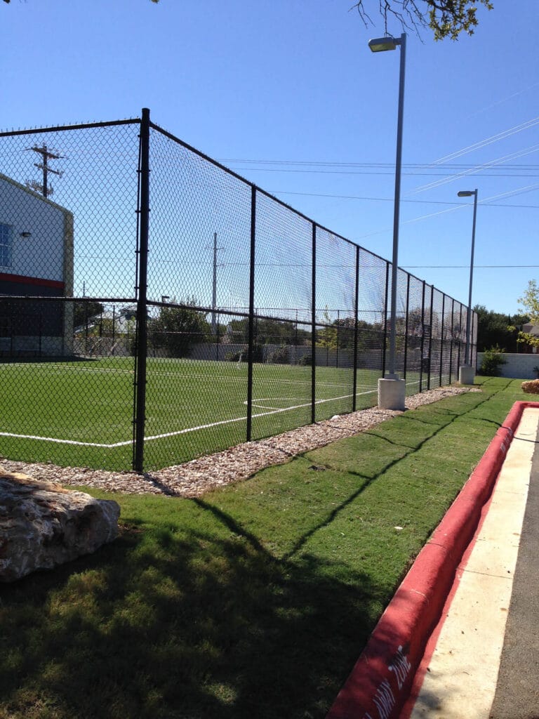 Ten-foot black vinyl chain link sports court fence built for long-term strength and visibility.